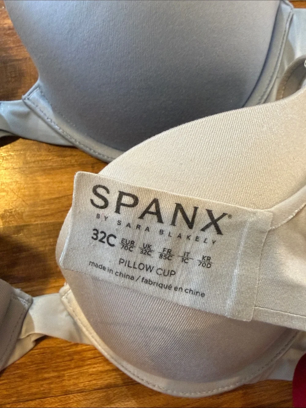 Three-pack SPANX Smooth T-Shirt Bras in Light Blue, Cream, and Red